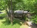Secluded home exterior with lush green trees and driveway leading to carport at 4352 Treeline Way, Douglasville, GA 30135