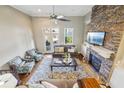 Open living area with a stone fireplace, ample seating, and natural light from large windows at 255 Southerland Ne Ter # 207, Atlanta, GA 30307