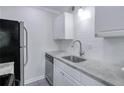 This kitchen has stainless steel appliances, white cabinets, and subway tile backsplash at 86 De Arc Nw Pl, Atlanta, GA 30327
