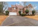 Beautiful two-story brick home with a well-manicured lawn and mature landscaping at 1647 Club Vista Trce, Stone Mountain, GA 30088