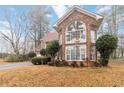 Beautiful two-story brick home with a well-manicured lawn and mature landscaping at 1647 Club Vista Trce, Stone Mountain, GA 30088