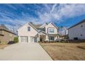 Beautiful two-story home with a two-car garage, showcasing its well-maintained lawn at 614 Denali Dr, Mableton, GA 30126