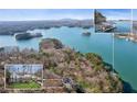 Scenic aerial view showcasing lakefront property and a private dock with boat slip at 7530 Heard Rd, Cumming, GA 30041