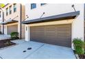 Close-up shot of a townhome garage with a modern design and well-kept landscaping at 1012 Rohner Way, Smyrna, GA 30080