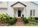 Home's entry offers a brick path leading to the front door with garden-like landscaping at 1054 Club Ne Pl, Atlanta, GA 30319