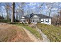 Beautifully landscaped front yard with stone accents and a charming single-story home at 6170 Wellington Ct, Cumming, GA 30040