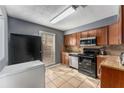Functional kitchen equipped with black appliances, wood cabinets, and tile backsplash at 2340 Beaver Ruin Rd # 68, Norcross, GA 30071