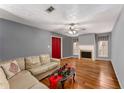 Comfortable living room featuring hardwood floors, a ceiling fan, and a cozy fireplace at 2340 Beaver Ruin Rd # 68, Norcross, GA 30071