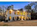 Charming two-story home with a symmetrical facade, warm exterior lighting, and a well-manicured front lawn at 4132 Carmain Ne Dr, Atlanta, GA 30342