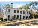Beautiful two-story home boasting a modern design, black-framed windows, and a lush green front yard at 4132 Carmain Ne Dr, Atlanta, GA 30342
