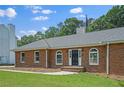 Inviting brick facade with a well-kept lawn, arched windows, and a stately entrance at 9035 Teal Ln, Jonesboro, GA 30236
