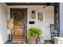 Cozy porch with stained wood door, greenery, and classic West End signage at 1171 Eggleston Sw St, Atlanta, GA 30310