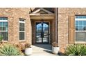 Close-up of the home's front entrance featuring a decorative glass door and manicured plants at 5669 Casa Blanca Ln, Atlanta, GA 30331