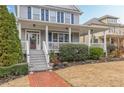 Close-up of charming covered front porch with white columns and a brick walkway at 3673 Howard Dr, College Park, GA 30337