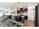 Modern kitchen featuring a breakfast bar with stylish upholstered stools and stainless steel appliances at 1405 Lyon Way Dr, Lawrenceville, GA 30044
