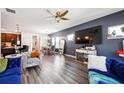 Open-concept living room with a view into the dining area and kitchen, featuring sleek flooring at 1405 Lyon Way Dr, Lawrenceville, GA 30044