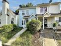 Charming townhome showcasing neat landscaping, blue and beige siding, and a cozy front entrance at 5916 Dogwood Mnr, Lithonia, GA 30038