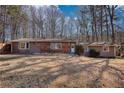 Charming one-story home with a brick accent and mature trees surrounding the property at 115 Hollybrook Rd, Atlanta, GA 30349
