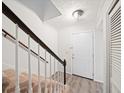 Hallway with a carpeted staircase and wood-look flooring at 4126 N Gloucester Pl, Atlanta, GA 30341