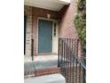 Close-up of the front door, featuring brick and steel with convenient access to stairs at 5027 Bayrose Cir # 27A, Atlanta, GA 30344