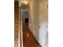 Hallway featuring hardwood floors, with stairs on the left and access to rooms ahead at 5027 Bayrose Cir # 27A, Atlanta, GA 30344