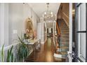 Entryway with hardwood floors, stairs to the right, and a mirror on the left, under a chandelier at 17 Willow Ne Gln, Atlanta, GA 30342