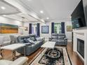 Living room with hardwood floors, two sofas, two side tables, and a fireplace with a TV above at 17 Willow Ne Gln, Atlanta, GA 30342