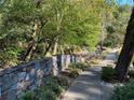 Scenic community walking path along a stone wall, ideal for peaceful strolls and nature appreciation at 23210 Plantation Ne Dr, Atlanta, GA 30324