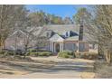 Charming brick home featuring a well-kept lawn and a welcoming circular driveway at 1725 Patriots Nw Way, Kennesaw, GA 30152