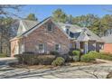 A view of the side of this beautiful brick home with mature landscaping at 1725 Patriots Nw Way, Kennesaw, GA 30152