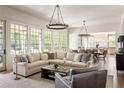 Open-concept living room featuring hardwood floors, a comfortable seating area, and natural lighting at 2629 Ashford Ne Rd, Brookhaven, GA 30319