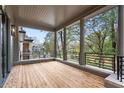 Spacious porch with wooden floors, decorative columns, and black metal railings with city view at 96 Sheridan Dr, Atlanta, GA 30305