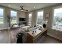 Cozy living room with large windows, comfortable seating, ceiling fan, and a balcony view at 968 Bibbs Circle Nw, Atlanta, GA 30318