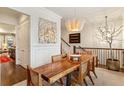 Stylish dining room with hardwood floors, modern light fixture, and access to kitchen at 2111 Lilly Nw Way, Atlanta, GA 30318