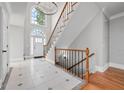 Open foyer with soaring ceiling, staircase and white tile flooring at 305 Brassy Ct, Alpharetta, GA 30022