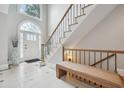 Bright foyer with decorative tile, soaring windows, and a staircase at 305 Brassy Ct, Alpharetta, GA 30022