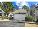 The home has a spacious two-car garage with a paved driveway at 305 Brassy Ct, Alpharetta, GA 30022