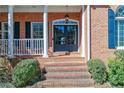 Inviting front porch with brick steps, white columns, and well-maintained landscaping at 3894 Stone Lake Nw Dr, Kennesaw, GA 30152