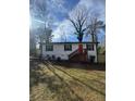 Charming single story home with white siding, black shutters, and a bright red front door at 1753 Lee St, Decatur, GA 30035