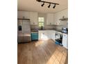 Modern kitchen featuring stainless steel appliances and sleek white cabinetry at 1753 Lee St, Decatur, GA 30035