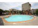 Beautiful community pool surrounded by lounge chairs and lush landscaping at 898 Oak # 3421, Atlanta, GA 30310