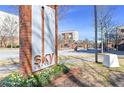Brick and metal 'Sky Lofts' community sign amidst flowers and landscaping at 898 Oak # 3421, Atlanta, GA 30310