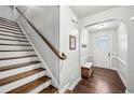 Welcoming entryway features hardwood floors, staircase, and an arched entrance into the home at 1989 Brightleaf Way # 143, Marietta, GA 30060