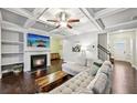 Spacious living room features a coffered ceiling, fireplace, and a comfortable sectional sofa at 1989 Brightleaf Way # 143, Marietta, GA 30060