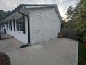 View of the exterior of the house with a view of the side yard and driveway at 6977 Eunice Dr, Riverdale, GA 30274