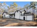 View of the back of the home, showcasing a elevated patio and neutral color palette at 1675 Dodson Sw Dr, Atlanta, GA 30311