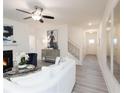 Open-concept living area featuring a fireplace, staircase and abundant natural light creating an inviting atmosphere at 1622 Aiden Way # 62, Conyers, GA 30013