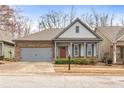 Charming single-story home showcasing a stone facade, gray siding, and a welcoming front porch at 250 High Court Way, Locust Grove, GA 30248