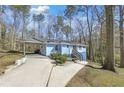 Light blue single-story home featuring a carport and a neatly maintained driveway at 298 Harper Se Rd, Atlanta, GA 30315