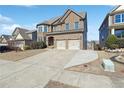Beautiful two-story brick home featuring an attached two-car garage and expansive driveway at 615 Ceremony Way, Acworth, GA 30102
